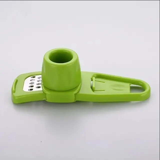 Green mini manual garlic grinder with a plastic blade